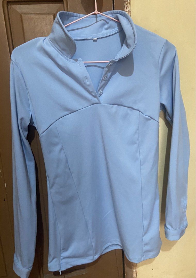 Light Blue Long Sleeve Button Polo Blouse (Category: Longsleeves) located in Baguio. Submitted by sasissey (Listing ID 1464903234, Image 2). Description: - Color: Light blue - Neckline: Mock collar with front button placket - Fit: Fitted silhouette with panel seams - Sleeves: Long sleeves with single-button cuffed wrists - Material: Smooth, solid fabric.
