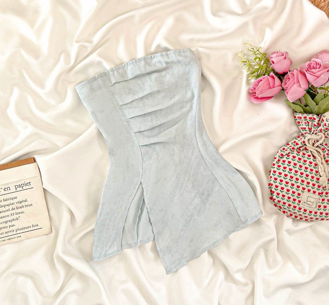 Light blue strapless tube top with front slit (Category: Sleeveless) located in Manila. Submitted by preloved_tweeds_ph (Listing ID 1464808021, Image 1). Description: small to medium - Color: Light blue - Design: Strapless tube top with chic chest pleats and an asymmetrical front slit - Material: Soft and comfortable textured fabric - Styling: Perfect to pair with high-waisted jeans or skirts - Occasion: Ideal for casual hangouts or night events.