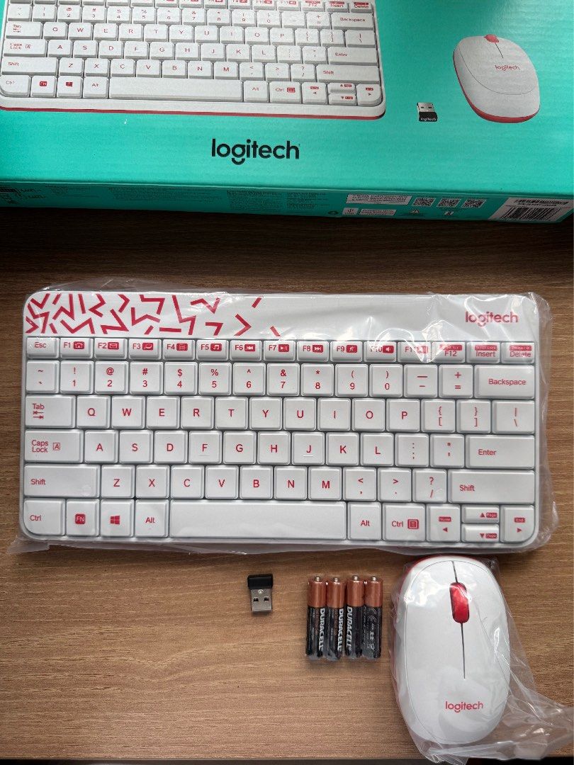 Logitech MK240 Nano Wireless Keyboard And Mouse (Category: Computer Keyboard) located in Rizal. Submitted by yowfaveariesdeclutter (Listing ID 1464827188, Image 1). Description: - Model: Logitech MK240 Nano Wireless Keyboard and Mouse Set - Design: Eye-catching white and red color scheme with abstract pattern - Condition: Brand new, unused contents inside original packaging - Inclusions: Original box, USB receiver, and fresh Duracell batteries - 