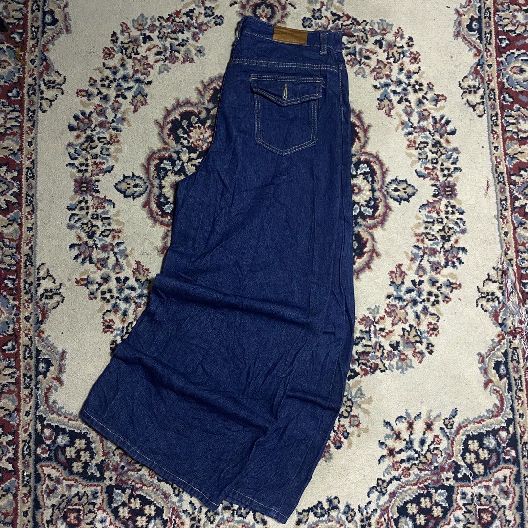 Long denim skirt with back pocket (Category: Skirts) located in Manila. Submitted by thrifturfit_star (Listing ID 1464942568, Image 1). Description: - Color: Dark blue denim - Cut: Flared style long skirt - Details: Unique back flap pocket and brown leather patch near the waistband - Material: Thick, durable denim fabric - Fit/Use: Great staple piece for casual everyday outfits.