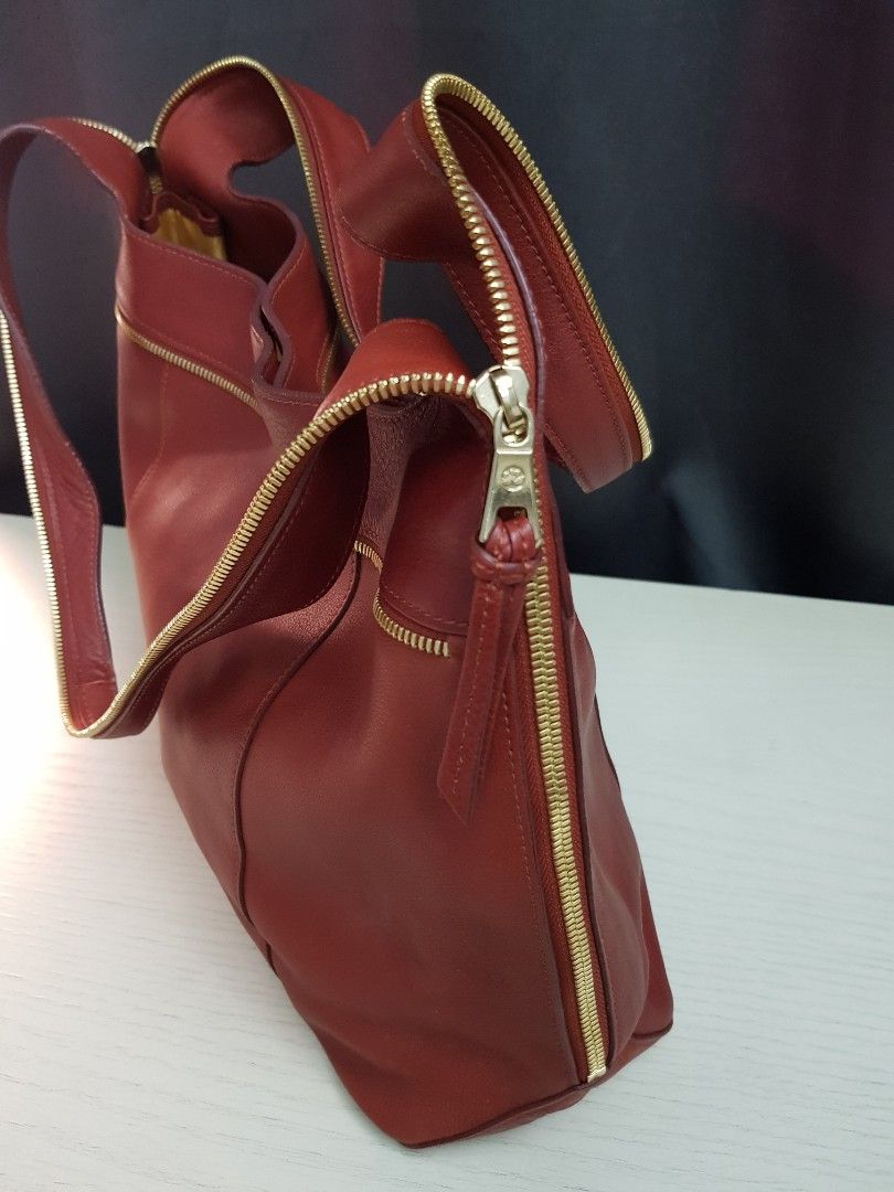 Longchamp Red Leather Shoulder Bag (Category: Luxury Bags & Wallets) located in Mandaluyong City. Submitted by bestill4610 (Listing ID 1464905332, Image 3). Description: Authentic Rare Longchamp Shoulder Bag Nice brick red leather Gold zipper on strap & sides Bought in Rustan's. Never used. L" 16" x H 10" x Base 4".