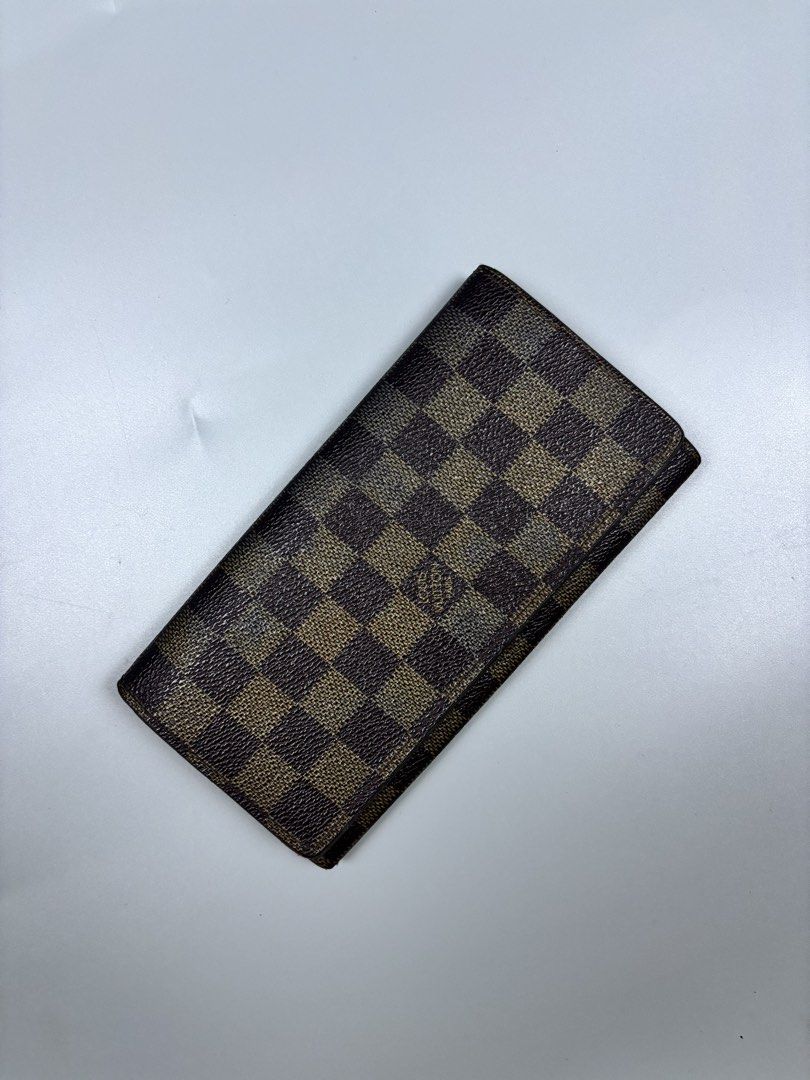 Louis Vuitton Damier Ebene Long Wallet (Category: Luxury Bags & Wallets) located in Mabalacat. Submitted by doughnutthrift (Listing ID 1464888809, Image 2). Description: - Louis Vuitton long wallet in classic Damier Ebene brown checkerboard canvas - Features gold-tone hardware, multiple card slots, and a secure zippered coin compartment - Clear date code stamped inside for authenticity - Exterior canvas is in great, well-kept condition - Normal p