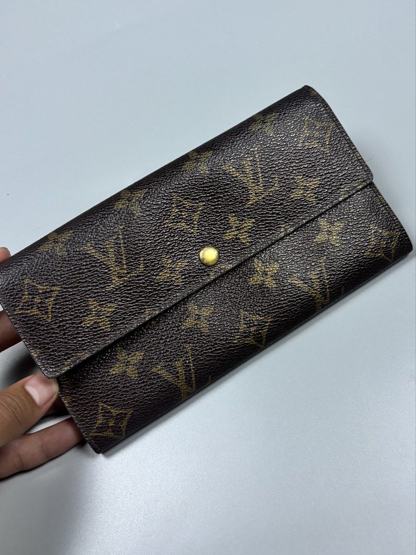 Louis Vuitton Monogram Canvas Sarah Wallet (Category: Luxury Bags & Wallets) located in Mabalacat. Submitted by doughnutthrift (Listing ID 1464888558, Image 1). Description: - Authentic Louis Vuitton long wallet in the iconic brown monogram canvas - Secure front flap with snap button closure - Elegant gold-tone hardware featuring LV engraving - Spacious interior compartments for effortless organization of cards and cash - Classic design that neve