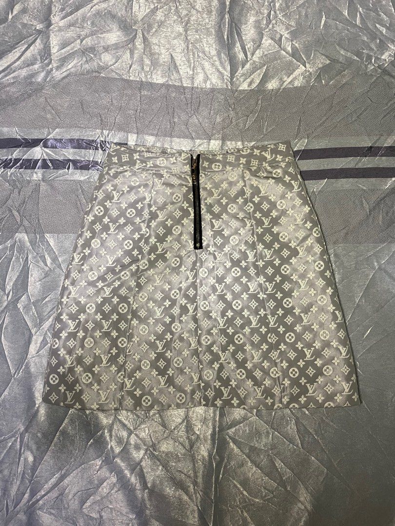 Louis Vuitton Monogram Jacquard Mini Skirt Grey White (Category: Skirts) located in San Fernando. Submitted by theglobalgoods (Listing ID 1464780695, Image 1). Description: - Authentic-style grey and white LV monogram pattern - Trendy double front zipper design with custom branded hardware - Black leather-look waist buckle accented with gold grommets and LV logo button - Fully lined with smooth white fabric for comfortable wear - Features the cla
