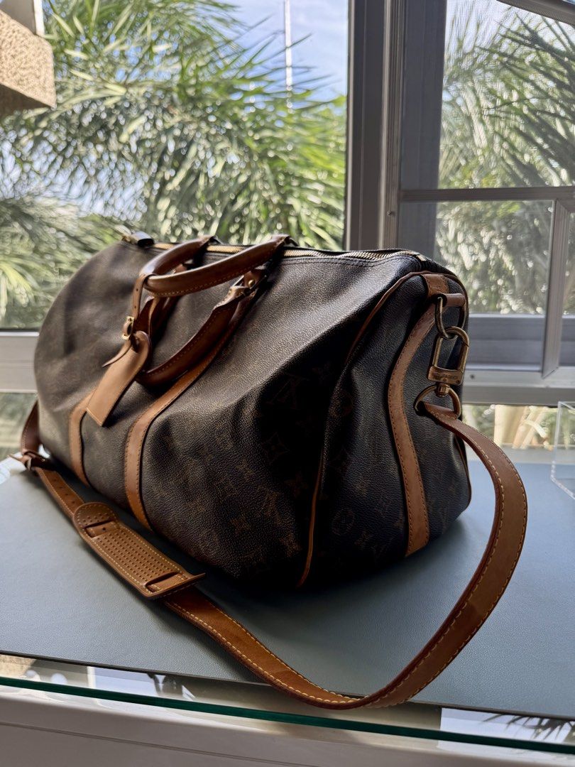 Louis Vuitton Monogram Keepall Bandoulière Duffle Bag (Category: Luxury Bags & Wallets) located in Muntinlupa City. Submitted by chelseanne_1 (Listing ID 1464781576, Image 1). Description: - Authentic Louis Vuitton Monogram Keepall Bandoulière travel bag - Classic brown canvas featuring the signature LV monogram pattern - Vachetta leather trim with a natural honey patina from regular use - Includes sturdy top handles and a comfortable, adjustable
