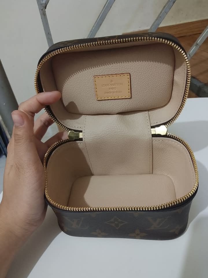 Louis Vuitton Nice Nano Monogram Vanity Pouch (Category: Luxury Bags & Wallets) located in Quezon City. Submitted by luxuriesbymichiika (Listing ID 1464902450, Image 3). Description: - Authentic Louis Vuitton Nice Nano vanity case in classic Monogram canvas - Features premium gold-tone hardware, natural cowhide leather trim, and a sturdy top handle - Dual zip closure opening to a beige washable interior lining with a convenient flat pocket - Comp