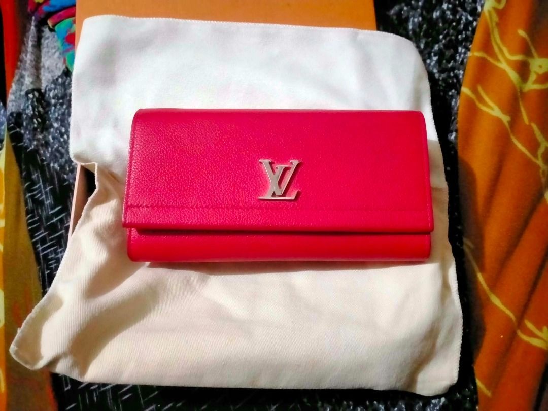 Louis Vuitton Red Long Wallet (Category: Luxury Bags & Wallets) located in Lucban. Submitted by giankarlot91217 (Listing ID 1464937350, Image 2). Description: - Brand: Louis Vuitton - Style: Long wallet - Color: Bright red - Material: Textured leather - Hardware: Silver-tone LV front clasp - Interior: Multiple card slots and coin compartment - Inclusions: Original orange box and dust bag - Condition: Excellent, classic piece.
