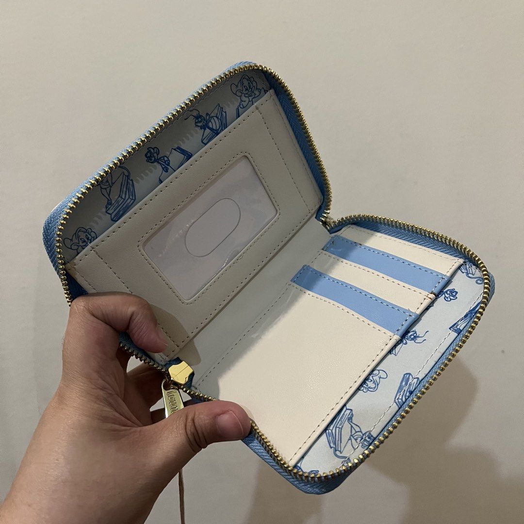 Loungefly Disney Princess Book Stack Zip Around Wallet (Category: Wallets & Card holders) located in San Pedro. Submitted by rainyydayy (Listing ID 1464856365, Image 3). Description: With flaw sa back side (slice) see photo.