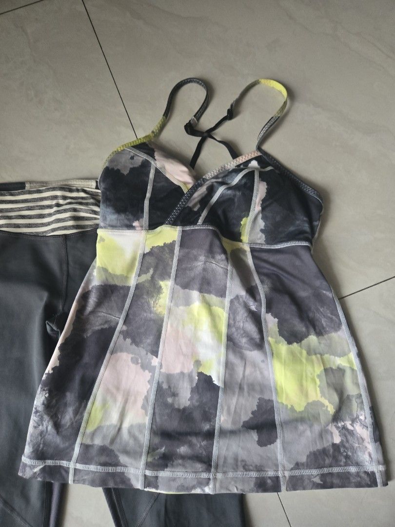 Lululemon Activewear Set Top and Leggings (Category: Activewear) located in Pasig City. Submitted by izzy0202 (Listing ID 1464825164, Image 3). Description: Lululemon workout set. Tank top features abstract watercolor pattern in grey, yellow, and white with adjustable straps and built-in bra. Matching dark grey leggings have mesh panels and striped contrast cuffs at the ankles. Iconic Lululemon omega logo printed on the leg. Great outfit for gym 