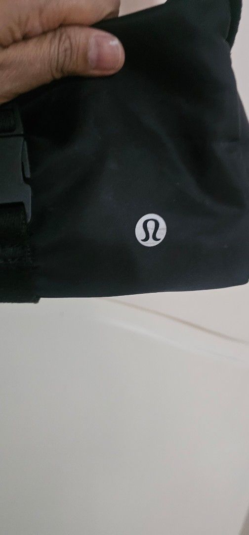 Lululemon Black Crossbody Bag (Category: Cross-body Bags) located in Davao. Submitted by sachigo (Listing ID 1464807006, Image 2). Description: - Brand: Lululemon - Color: Classic Black with white logo - Material: Durable, water-resistant nylon - Closure: Secure front buckle strap - Pockets: Exterior zip pocket and multiple interior compartments - Strap: Adjustable for custom comfort - Use: Ideal for gym sessions, travel, and daily errands - Cond