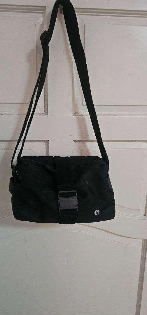 Lululemon Black Crossbody Bag (Category: Cross-body Bags) located in Davao. Submitted by sachigo (Listing ID 1464807006, Image 1). Description: - Brand: Lululemon - Color: Classic Black with white logo - Material: Durable, water-resistant nylon - Closure: Secure front buckle strap - Pockets: Exterior zip pocket and multiple interior compartments - Strap: Adjustable for custom comfort - Use: Ideal for gym sessions, travel, and daily errands - Cond