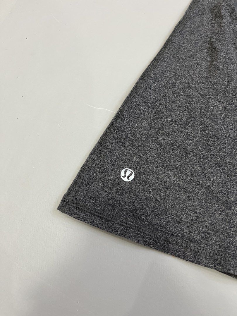 Lululemon Grey Racerback Tank Top With Ruched Back (Category: Sleeveless) located in Mabalacat. Submitted by aas_thriftfings (Listing ID 1464784857, Image 2). Description: - Brand: Lululemon - Style: Racerback tank top with gathered ruching down the middle of the back - Color: Grey heathered - Details: Signature white Lululemon logo near the bottom hem - Material: Lightweight, stretchy, and breathable fabric - Ideal for: Workouts, gym sessions, o