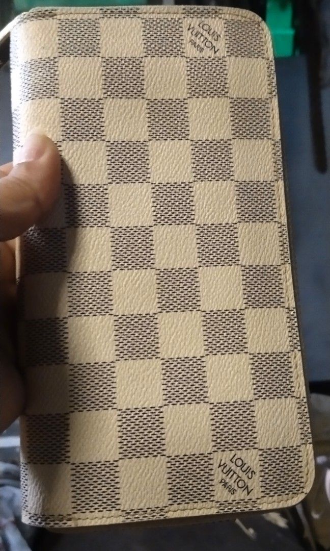 LV damier azur zippy wallet (Category: Luxury Bags & Wallets) located in Trece Martires City. Submitted by vherma (Listing ID 1464775132, Image 1). Description: Louis Vuitton Damier Azur Zippy Wallet. Visible Details Pattern: Cream and blue-gray or light gray checkered Damier Azur canvas. Markings: Distinct "LOUIS VUITTON PARIS" signatures printed on the canvas squares near opposite corners. Design: Long, structured rectangular shape with rounded