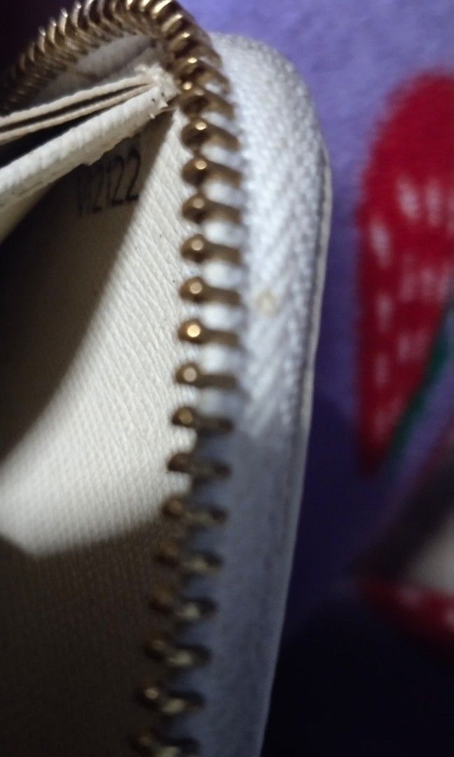 LV damier azur zippy wallet (Category: Luxury Bags & Wallets) located in Trece Martires City. Submitted by vherma (Listing ID 1464775132, Image 3). Description: Louis Vuitton Damier Azur Zippy Wallet. Visible Details Pattern: Cream and blue-gray or light gray checkered Damier Azur canvas. Markings: Distinct "LOUIS VUITTON PARIS" signatures printed on the canvas squares near opposite corners. Design: Long, structured rectangular shape with rounded