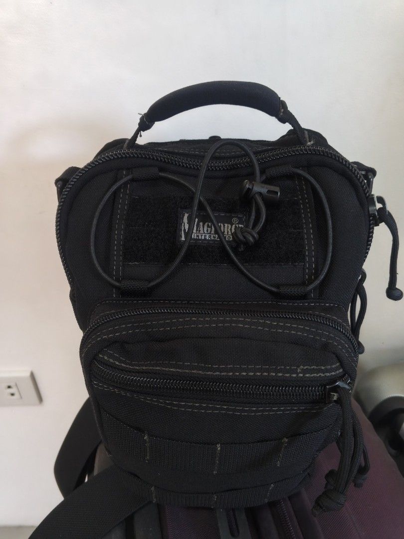 Magforce International Tactical Sling Bag Black (Category: Sling Bags) located in Tanza. Submitted by antares0048 (Listing ID 1464968523, Image 2). Description: - Authentic Magforce International tactical sling bag in sleek black - Built tough with durable nylon and heavy-duty zippers - Features multiple zipped compartments for easy organization - MOLLE webbing on front and sides for gear attachment - Comfortable padded top handle and breathable 