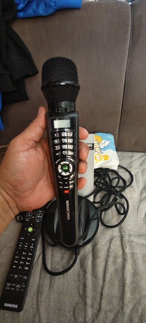 Magic Sing Karaoke System with Microphone and Remote (Category: Entertainment Systems & Smart Home Devices) located in Puerto Princesa. Submitted by gentleearth.a701ad (Listing ID 1464773415, Image 3). Description: - Complete Magic Sing karaoke set for home entertainment - Includes main base unit and wired microphone with built-in keypad - Comes with remote control, power adapter, song list booklet, and service center manual - All components show