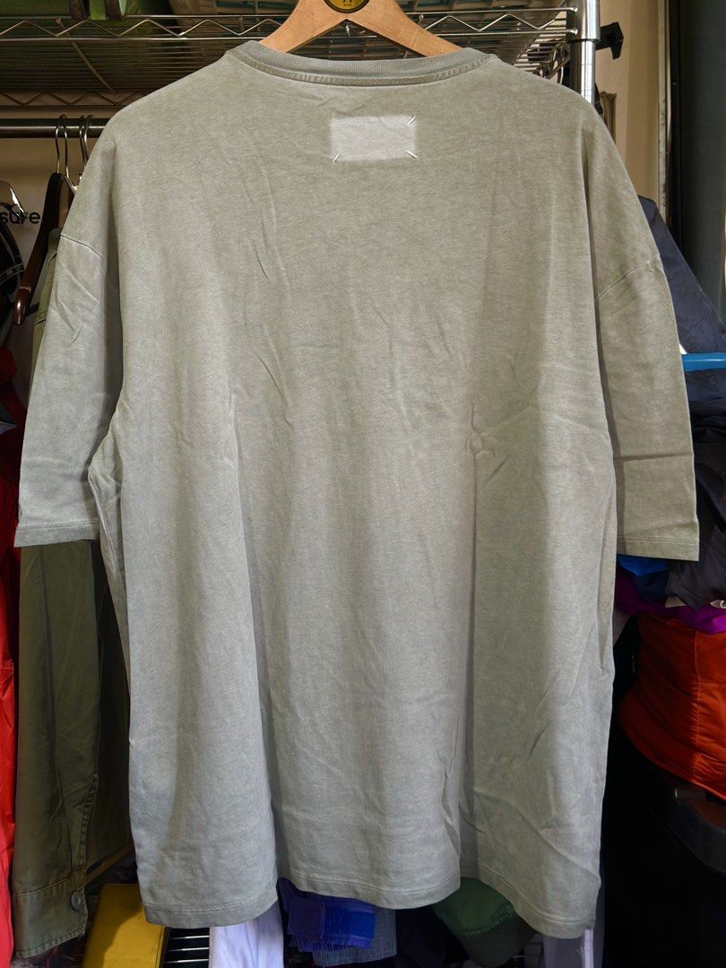Maison Margiela Olive Acid Washed Tee Size 48 (Category: Shirts) located in Daet. Submitted by thrifthings2018 (Listing ID 1464840190, Image 2). Description: - Brand: Maison Margiela - Item: Olive Acid-Washed T-Shirt - Size: 48 (Made in Italy) - Details: Iconic numeric tag on the back collar - Condition: Pre-owned, with minor stains on the sleeve as pictured.