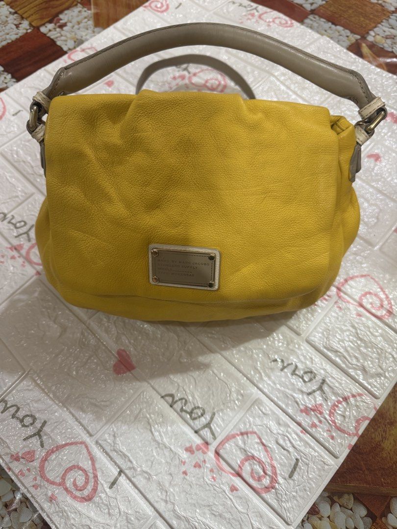 Marc by Marc Jacobs Yellow Leather Handbag (Category: Luxury Bags & Wallets) located in Manila. Submitted by wildbear.e10374 (Listing ID 1464800047, Image 1). Description: - Brand/Line: Marc by Marc Jacobs Standard Supply Workwear - Material: Bright yellow pebbled leather - Hardware & Straps: Gray top handle, matching gray shoulder strap, metallic hardware - Design: Front metal brand plaque, flap top closure, slouchy structure.