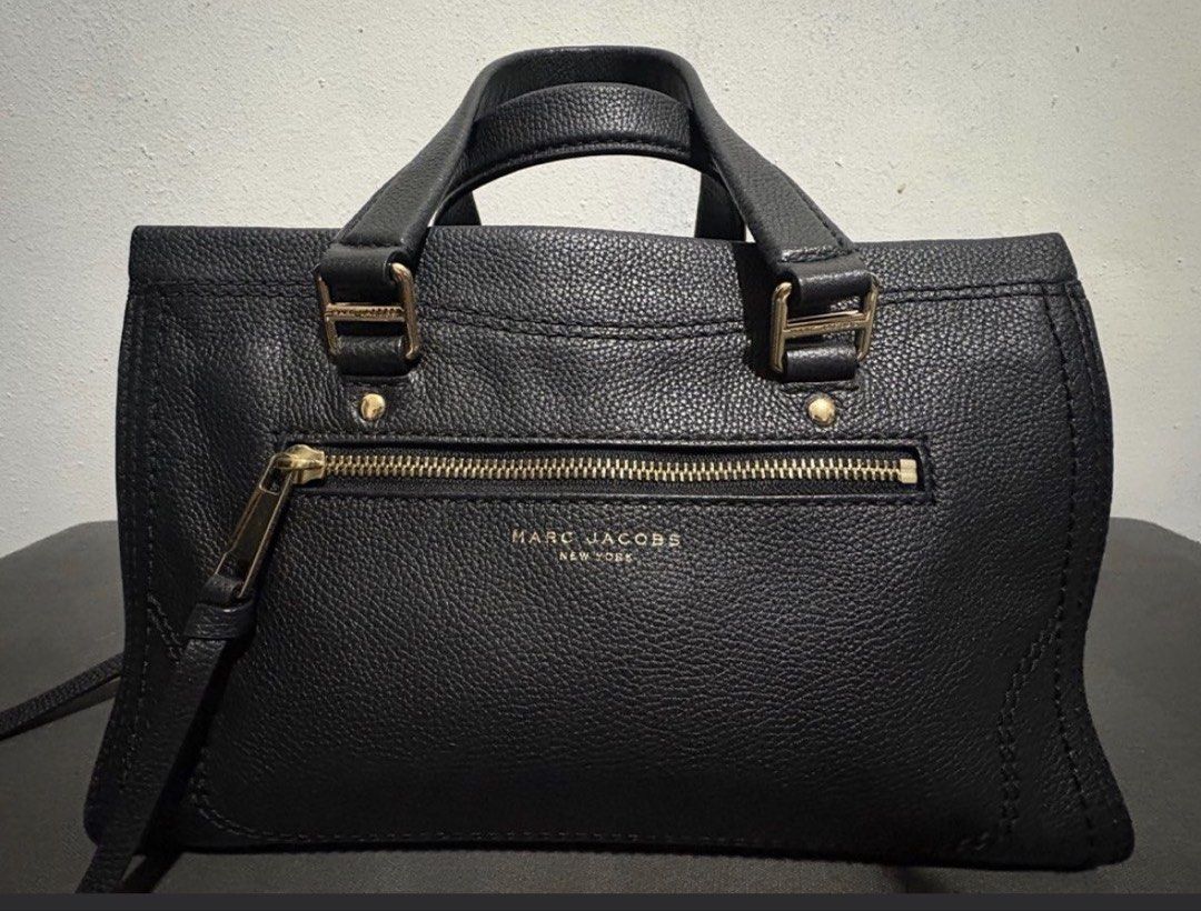 Marc Jacobs leather bag (Category: Shoulder Bags) located in Manila. Submitted by bwshoppe (Listing ID 1464880469, Image 1). Description: Marc Jacobs black leather bag can be carried in 2 ways, shoulder or hand bag with 1 zip outer pocket & 1 zip inner pocket. Comes with its original paper bag. Size: L 8”X W 12” X 6” base “A” mint conditon, very spacious inside. Purchased in Marc Jacobs shop in the US. .