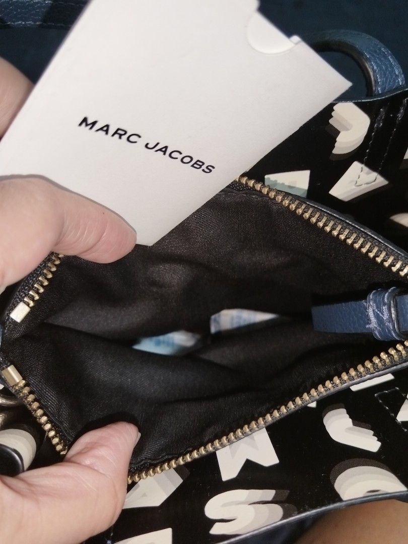 Marc Jacobs Leather Mini Grind Tote Bag Blue (Category: Tote Bags) located in Antipolo. Submitted by gievan0725 (Listing ID 1464864195, Image 2). Description: - Brand: Marc Jacobs - Style: Mini Grind Tote - Material: Textured blue leather - Hardware: Gold-tone with hanging padlock and key charm - Compartments: Zip top center compartment with open side sections and printed lining - Straps: Dual top handles and a detachable, adjustable crossbody st