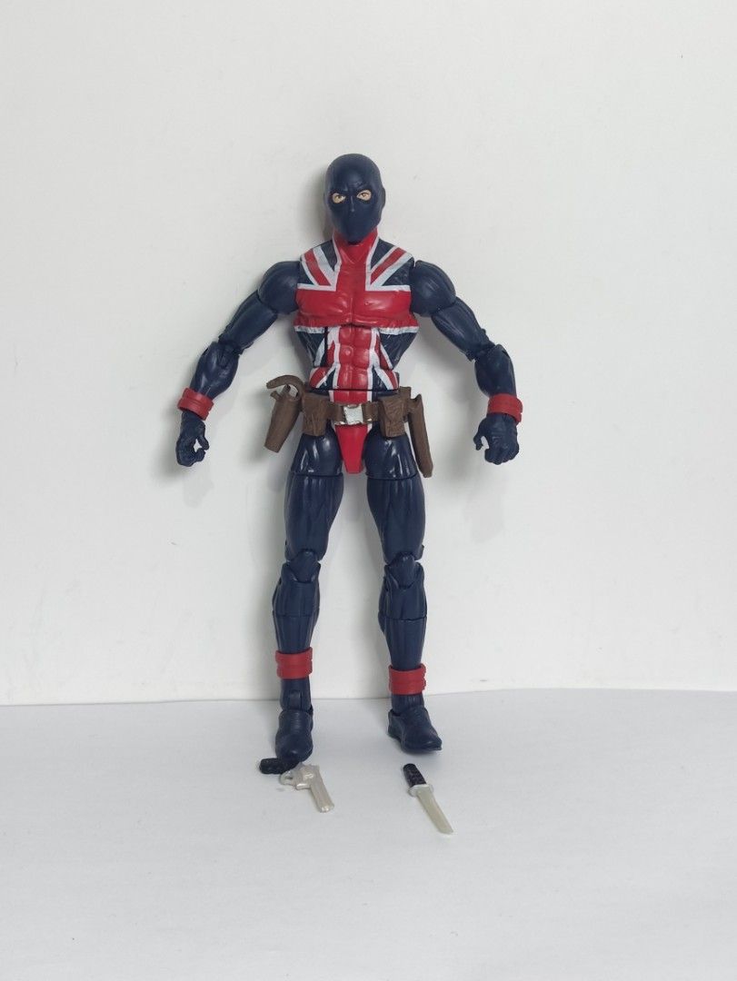 Marvel Legends Union Jack Action Figure with Accessories (Category: Figurines & Statues) located in Abucay. Submitted by lxtoyverse (Listing ID 1464837173, Image 1). Description: - Figure: Marvel Legends Union Jack - Attire: Dark blue suit with red and white Union Jack chest emblem - Accessories: Belt holster, loose pistol, and small knife - Articulation: Multiple points at shoulders, elbows, hips, and knees - Condition: Stands upright, painted f