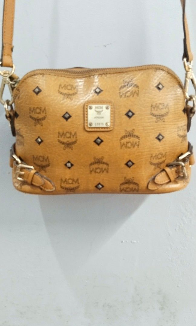 MCM visetos crossbody bag (Category: Luxury Bags & Wallets) located in Trece Martires City. Submitted by vherma (Listing ID 1464771560, Image 3). Description: The selected region appears to show a brown and tan monogram MCM Visetos Crossbody Bag featuring a signature diamond monogram print, gold-tone hardware, an adjustable shoulder strap, and a front logo plaque. Bag Features MCM monogram coated canvas body in cognac tan. Gold-tone metal hardwar