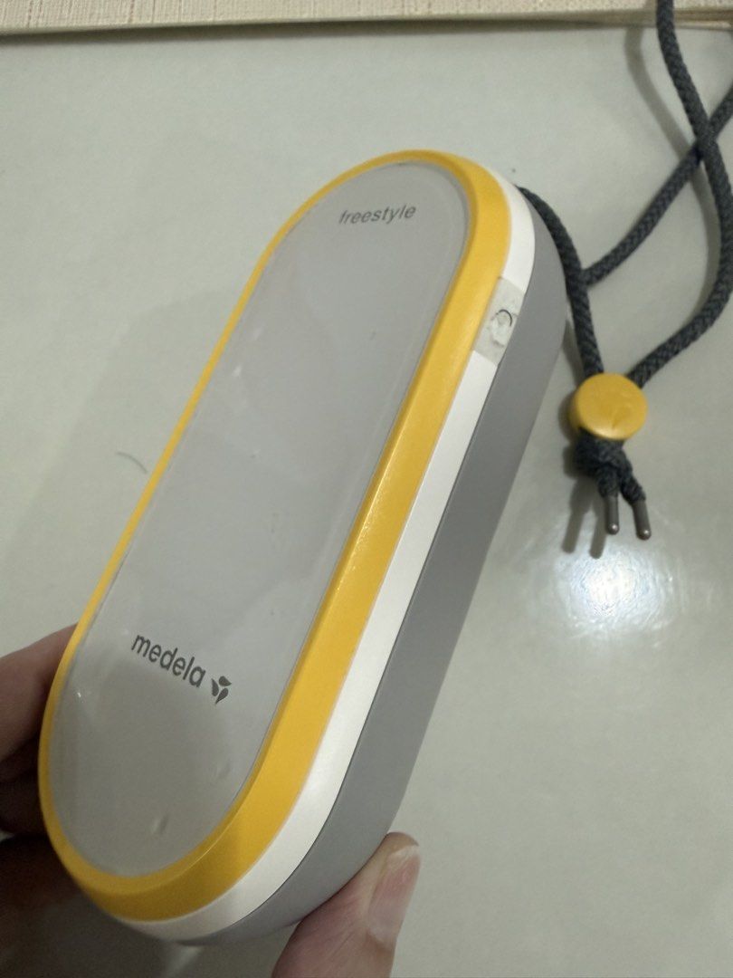 Medela Freestyle Double Electric Breast Pump Set (Category: Breastfeeding & Bottle Feeding) located in Manila. Submitted by ainamc (Listing ID 1464811576, Image 3). Description: - Complete Medela Freestyle breast pump set for pumping on the go - Includes motor unit with strap, main black tote bag, and cooler bag - Comes with 4 milk bottles, yellow caps, and a contoured blue ice pack - Multiple breast shields in various sizes, connector pieces, an