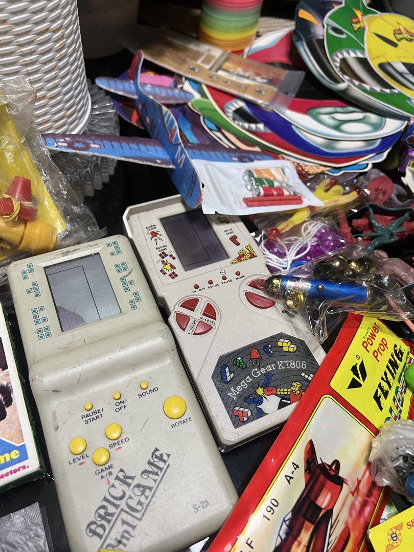 Memorabilia collectibles vintage (Category: Action & Battle Toys) located in Manila. Submitted by cterrineni76861 (Listing ID 1464884283, Image 3). Description: Massive collection of vintage childhood toys and games. Includes two classic brick game handheld consoles, wooden slingshot, plastic toy cars, blow balloon tubes, paper airplanes, marbles, 3D glasses, Dragon Ball boxes, and assorted novelty items. Nostalgic items for collectors or retro g