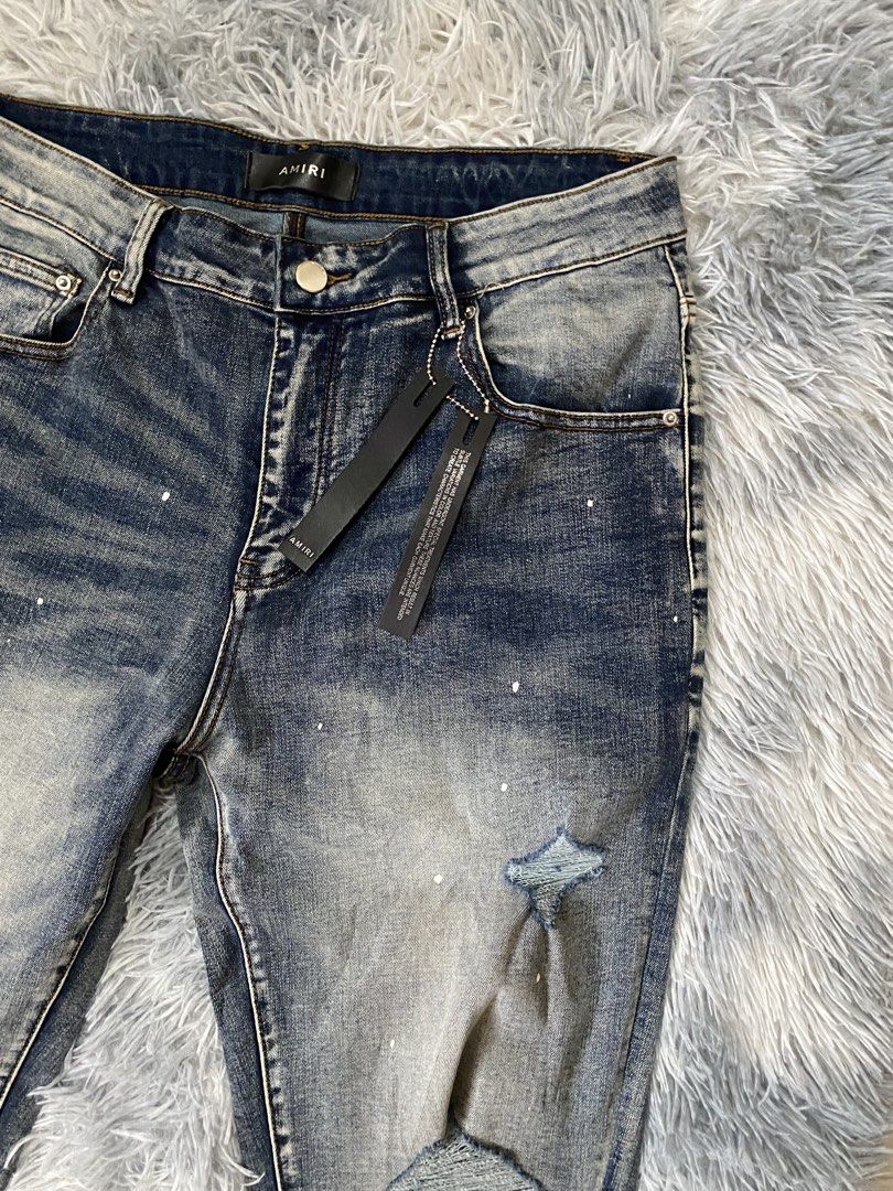 Men's Amiri Palm Trasher Jeans (Category: Jeans) located in Carmen. Submitted by yawbuangaka (Listing ID 1464824832, Image 3). Description: This is the distressed Amiri Palm Thrasher Jeans featuring a distinctive palm tree graphic and sunset-gradient wash near the cuffs. •Waistline - 34 •Length - 43 •Bnew with tags •Excellent.