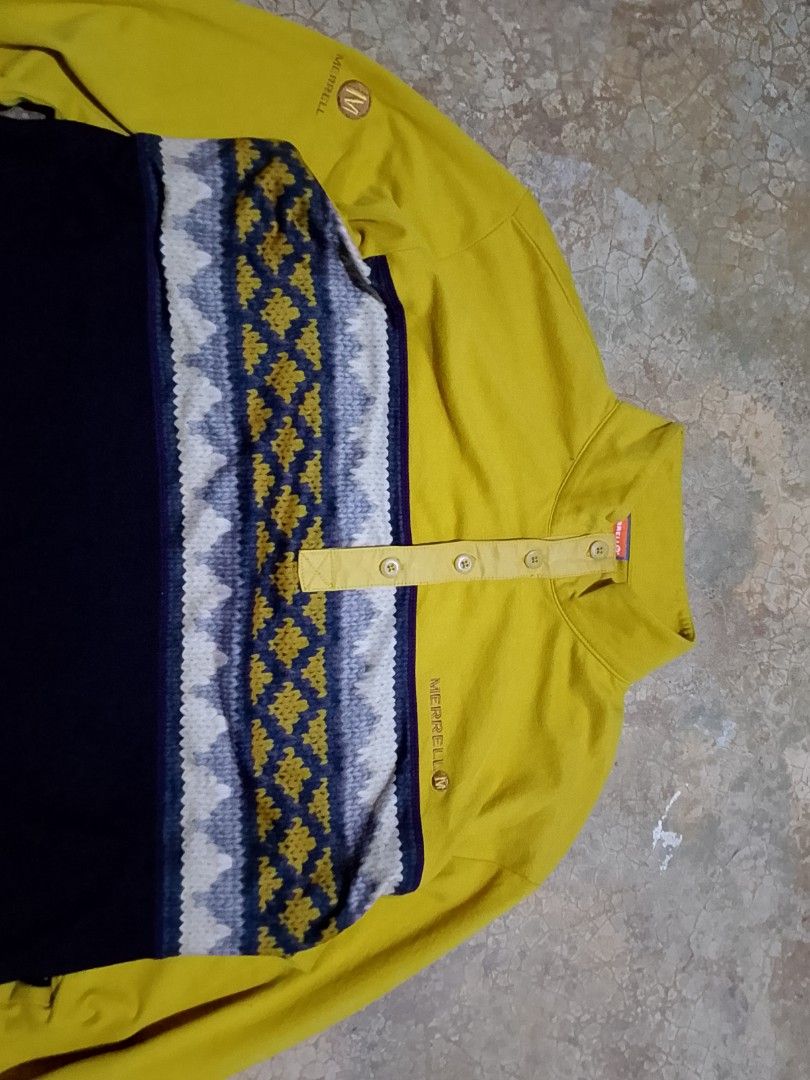 Merrell Long Sleeve Button Neck Pullover Yellow Navy Size L (Category: Coats, Jackets and Outerwear) located in Mandaue City. Submitted by thriftsyap (Listing ID 1464897564, Image 3). Description: - Brand: Merrell - Style: Long sleeve color block pullover shirt - Colors: Mustard yellow and dark navy blue - Features: High collar with button placket, patterned geometric chest band, embroidered branding on chest and sleeve, and small green 'M-Wick' 