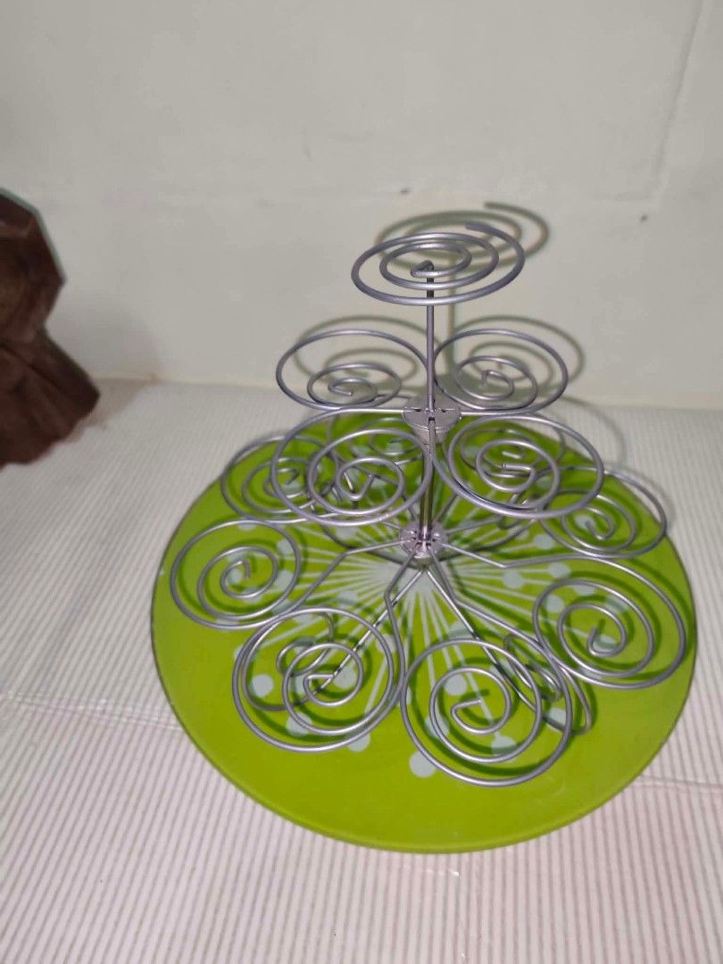 Metal Wire Cupcake Stand Multi-Tier Dessert Display (Category: Bakeware) located in Caloocan City. Submitted by gemmareas571129 (Listing ID 1464789877, Image 3). Description: - Multi-tier metal cupcake stand with secure silver wire spirals - Features a charming round green decorative base - Sturdy construction, perfect for parties, birthdays, and bake sales - Easy to assemble and take apart for convenient storage - Clean condition and ready to us