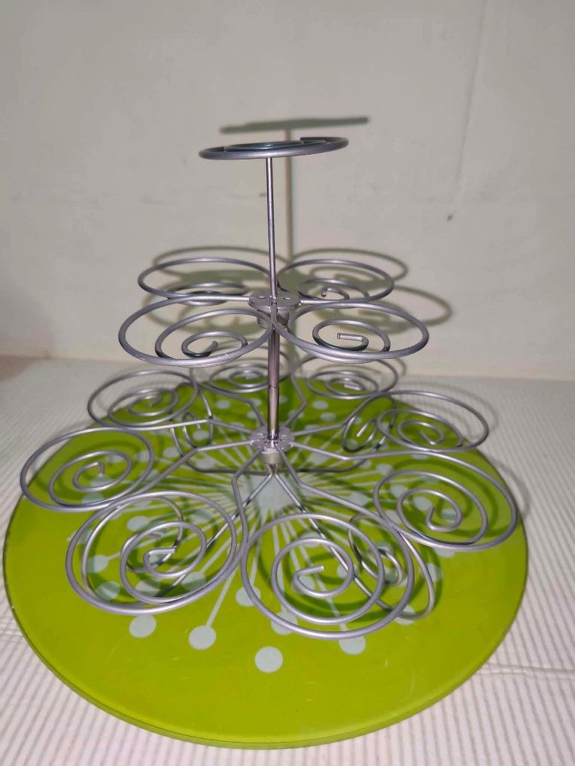 Metal Wire Cupcake Stand Multi-Tier Dessert Display (Category: Bakeware) located in Caloocan City. Submitted by gemmareas571129 (Listing ID 1464789877, Image 1). Description: - Multi-tier metal cupcake stand with secure silver wire spirals - Features a charming round green decorative base - Sturdy construction, perfect for parties, birthdays, and bake sales - Easy to assemble and take apart for convenient storage - Clean condition and ready to us