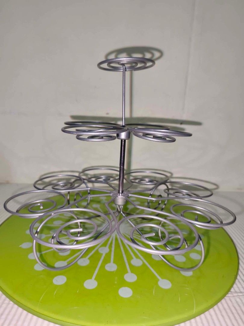 Metal Wire Cupcake Stand Multi-Tier Dessert Display (Category: Bakeware) located in Caloocan City. Submitted by gemmareas571129 (Listing ID 1464789877, Image 2). Description: - Multi-tier metal cupcake stand with secure silver wire spirals - Features a charming round green decorative base - Sturdy construction, perfect for parties, birthdays, and bake sales - Easy to assemble and take apart for convenient storage - Clean condition and ready to us