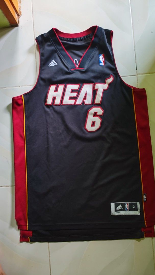 MIAMI HEAT X ADDIDAS LEBRON #6 (Category: Activewear) located in Manila. Submitted by christophermortz_08 (Listing ID 1464799137, Image 1). Description: - LeBron James Miami Heat jersey - Color: Black, red, and yellow - Number 6 on front and back, James on upper back - Adidas branding on chest with jock tag at hem - Size: Medium (Length +2 inches) - Material: 100% polyester - Made in Guatemala.