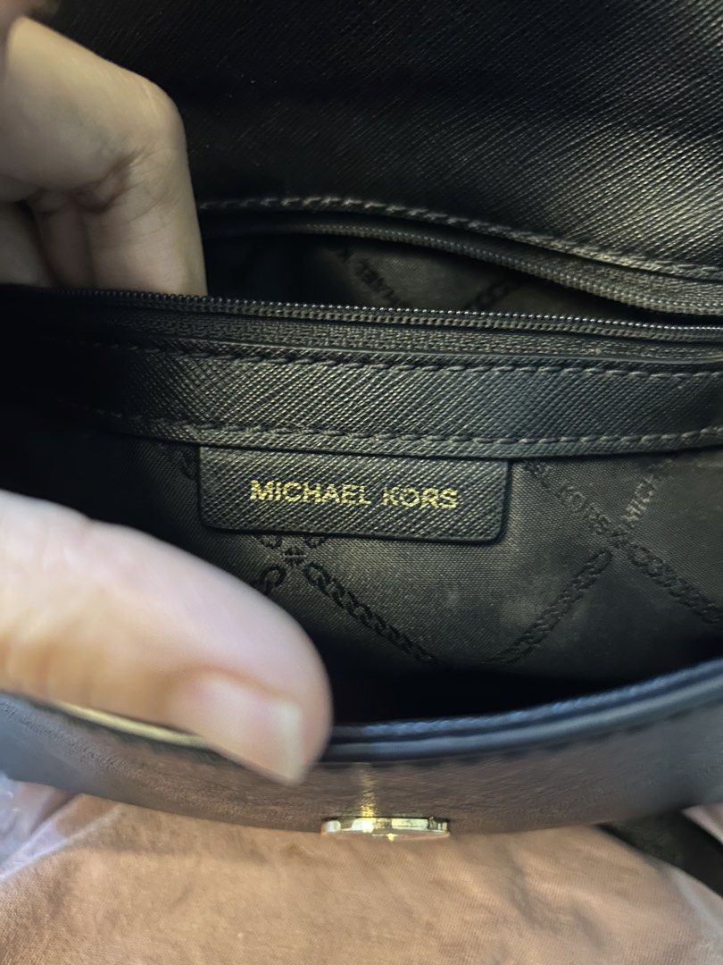 Michael Kors Black Crossbody Handbag (Category: Cross-body Bags) located in Manila. Submitted by gleglessie (Listing ID 1464928941, Image 2). Description: - Authentic black Michael Kors structured handbag - Made from scratch-resistant Saffiano leather with gold-tone hardware - Versatile design with top handle and a removable shoulder strap - Secure flap closure with magnetic side snap buttons - MK logo-lined interior featuring an inner zip pocket