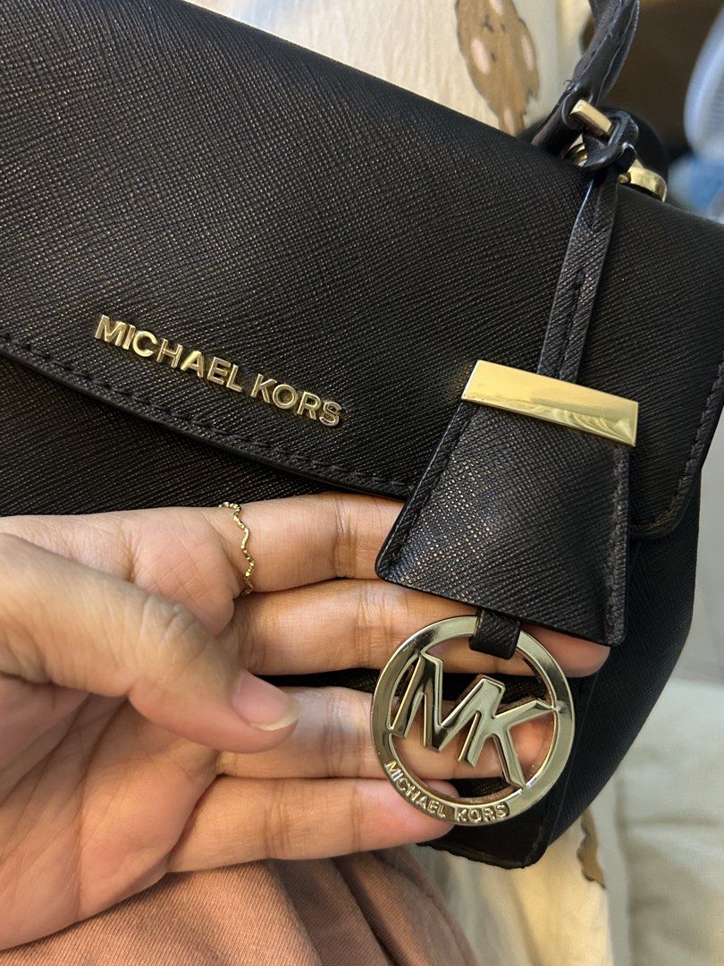 Michael Kors Black Crossbody Handbag (Category: Cross-body Bags) located in Manila. Submitted by gleglessie (Listing ID 1464928941, Image 3). Description: - Authentic black Michael Kors structured handbag - Made from scratch-resistant Saffiano leather with gold-tone hardware - Versatile design with top handle and a removable shoulder strap - Secure flap closure with magnetic side snap buttons - MK logo-lined interior featuring an inner zip pocket