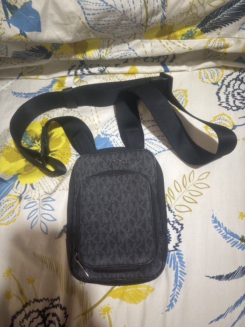 Michael Kors Black Monogram Crossbody Bag (Category: Sling Bags) located in Quezon City. Submitted by relyncabubas (Listing ID 1464784109, Image 1). Description: - Brand: Michael Kors - Style: Monogram crossbody bag - Color: Classic black - Exterior: Front zip pocket for quick access and dark hardware - Interior: Signature lining - Strap: Adjustable for custom comfort - Condition: Clean all around, ready to use.