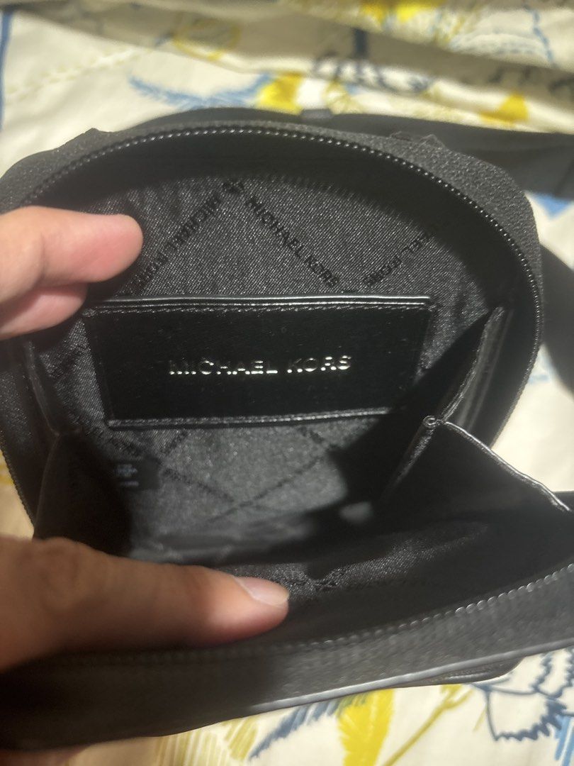 Michael Kors Black Monogram Crossbody Bag (Category: Sling Bags) located in Quezon City. Submitted by relyncabubas (Listing ID 1464784109, Image 3). Description: - Brand: Michael Kors - Style: Monogram crossbody bag - Color: Classic black - Exterior: Front zip pocket for quick access and dark hardware - Interior: Signature lining - Strap: Adjustable for custom comfort - Condition: Clean all around, ready to use.