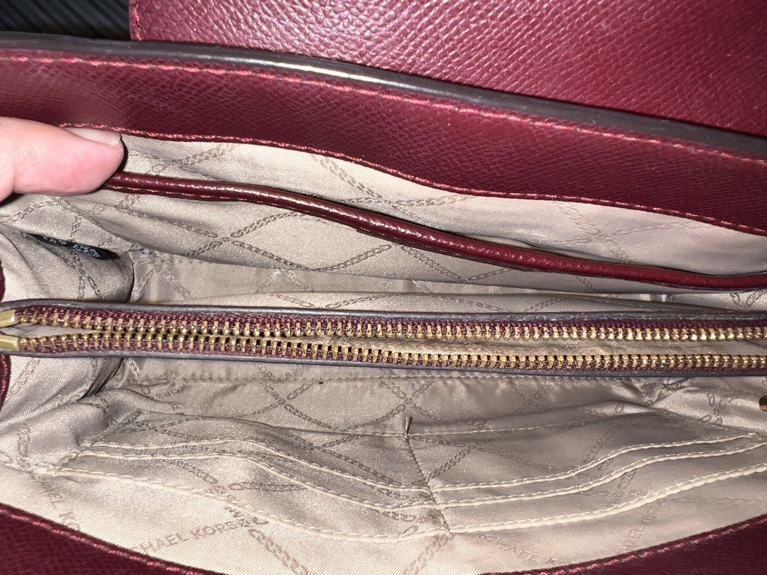 Michael Kors Burgundy Clutch (Category: Clutches) located in Baguio. Submitted by destashglam (Listing ID 1464786449, Image 2). Description: - Authentic Michael Kors crossbody bag in rich burgundy leather - Elegant gold-tone MK logo hardware with a magnetic snap front flap - Signature logo-print interior lining - Well-organized layout featuring multiple compartments, card slots, and a zippered middle section - 6 cards slot -lost strap but perfect