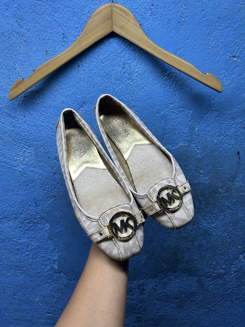 Michael Kors Logo Print Flats (Category: Flats & Sandals) located in Quezon City. Submitted by thriftxgoods (Listing ID 1464897683, Image 2). Description: - Brand: Michael Kors - Color: Beige with all-over signature MK monogram - Design: Round toe, slip-on style for easy everyday wear - Details: Gold-tone MK logo hardware buckle strap and metallic gold inner lining - Comfort: Fitted with rubber pod soles for extra grip.
