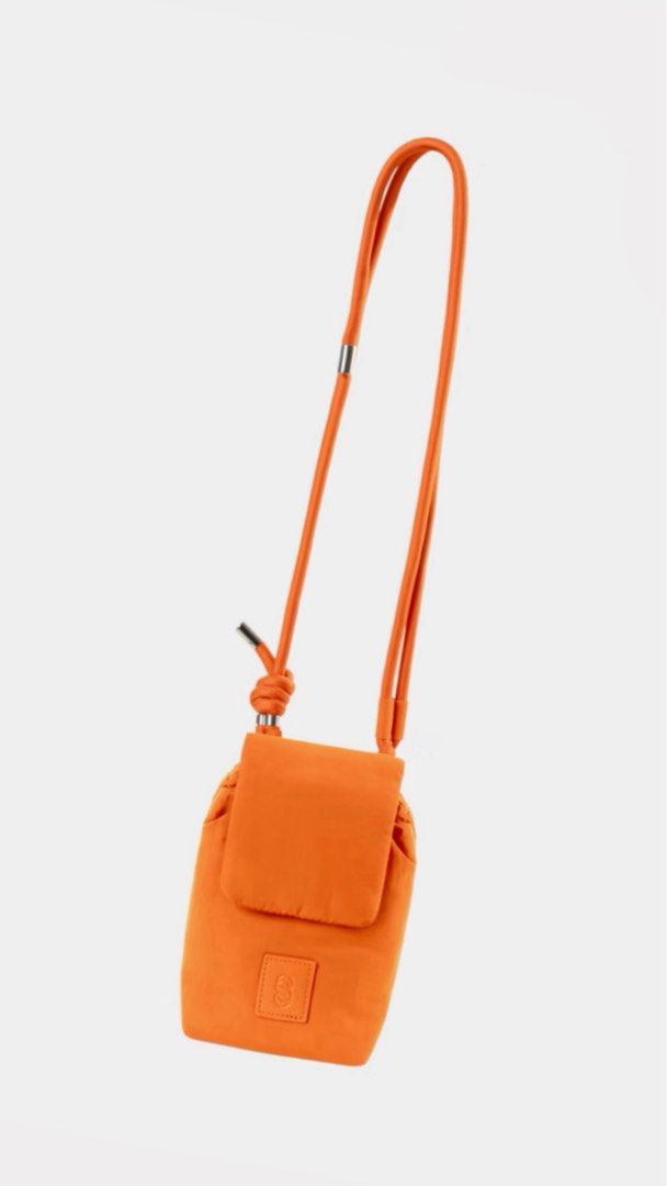Mini Crossbody Phone Bag (Category: Cross-body Bags) located in Cavite. Submitted by nikkatsu (Listing ID 1464841596, Image 1). Description: - Trendy mini crossbody bag designed for hands-free convenience - Features a secure flap pocket, drawstring closure, and stylish knotted rope strap - Compact size perfect for carrying daily essentials - Accented with a chic debossed logo patch on the front - Available in 4 vibrant colors: Orange, Olive Green