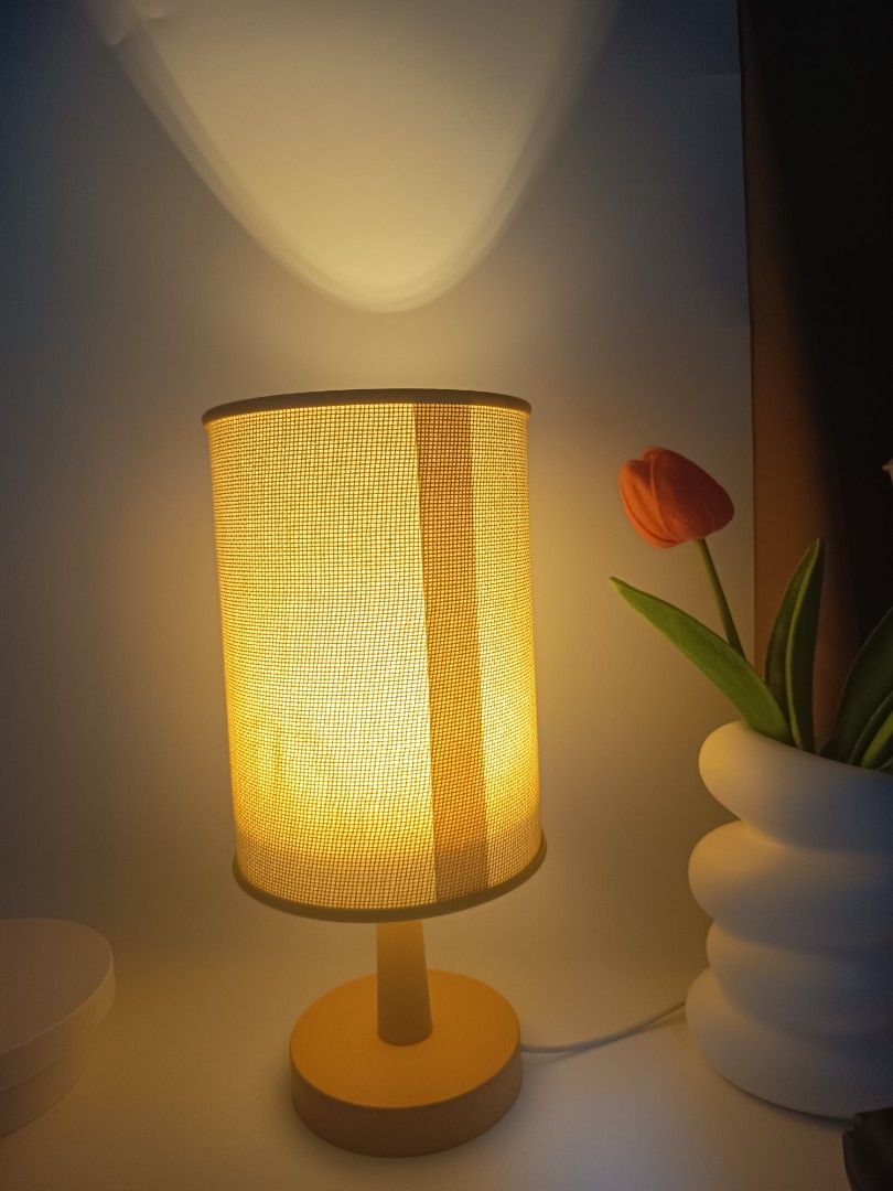 Minimalist beige bedside table lamp with cylindrical fabric shade (Category: Lighting) located in Manila. Submitted by heyjka_19xx (Listing ID 1464879335, Image 2). Description: - Color: Warm beige - Shade: Cylindrical woven fabric for soft yellow light - Base: Solid round matching neutral tone - Power: USB cord with convenient inline switch - Size: Compact, ideal for small bedside tables and desks - Vibe: Creates cozy ambient lighting for bedroo
