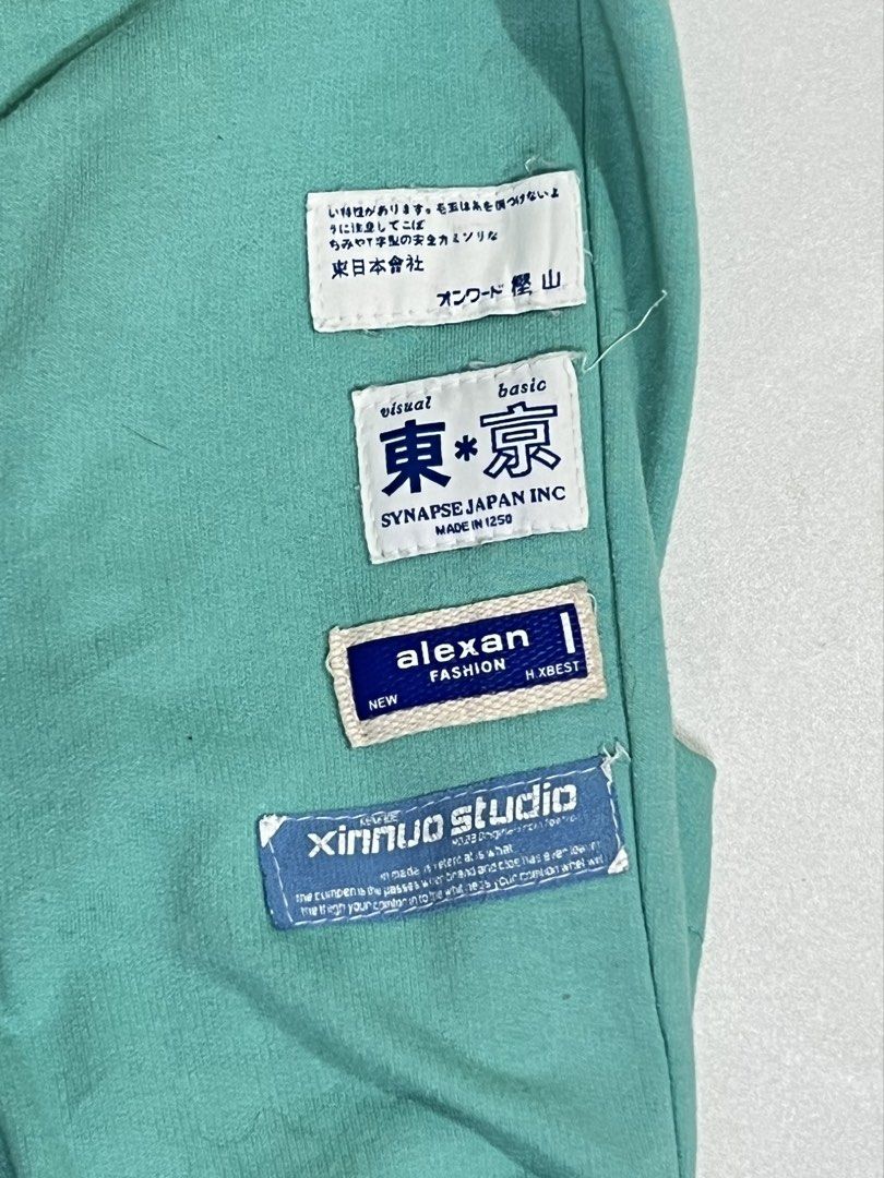 Mint green sweatpants with patchwork labels (Category: Joggers) located in Manila. Submitted by sennisen (Listing ID 1464912704, Image 2). Description: - Color: Mint green - Fit: Comfortable casual fit with an easy pull-on elastic waistband - Features: Functional side pockets and stylish decorative brand patches with Japanese text and Tokyo graphics near the cuff - Material: Soft, breathable cotton - Best for: Everyday streetwear or cozy lounging