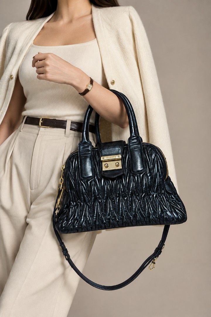 Miu Miu Matelassé Black Leather Bag (Category: Luxury Bags & Wallets) located in Baguio. Submitted by PreiLoveMaria (Listing ID 1464882121, Image 1). Description: Miu Miu Matelassé Black Leather Handbag (Japan Surplus Find!) ​Details: ​Style: Iconic Miu Miu matelassé pleated leather design featuring dual rolled top handles and gold-tone hardware. ​Closure & Accents: Front push-lock flap closure with the signature miu miu logo and dual top zippers