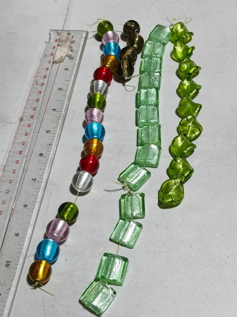 Mixed Murano-Style Glass Beads Strand Bundle (Category: Craft Supplies & Tools) located in Marikina City. Submitted by my-an (Listing ID 1464915541, Image 2). Description: Mixed Murano-Style Glass Beads Strand Bundle - 4 strands of assorted craft beads for DIY jewelry making - Includes round multicolored foil glass beads and dark gold-flecked round beads - Features pale green square tube beads and twisted leaf-shaped green beads - Strung on thin 