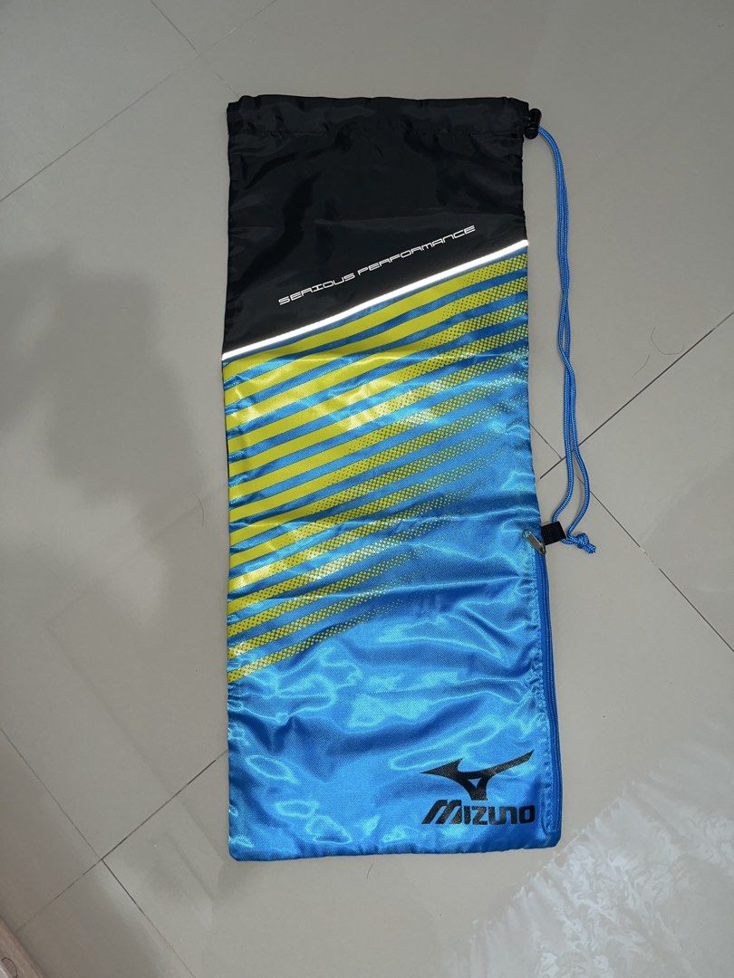 Mizuno Serious Performance Drawstring Racket Bag (Category: Backpacks) located in Daet. Submitted by UkayanNiAnj (Listing ID 1464780528, Image 2). Description: - Brand: Mizuno - Color: Blue, yellow, and black - Design: 'Serious Performance' text with a reflective stripe and iconic Mizuno Runbird logo - Storage: Zippered side pocket with smooth YKK puller - Closure: Blue drawstring - Condition: Excellent, clean with no noticeable flaws or wear. Br