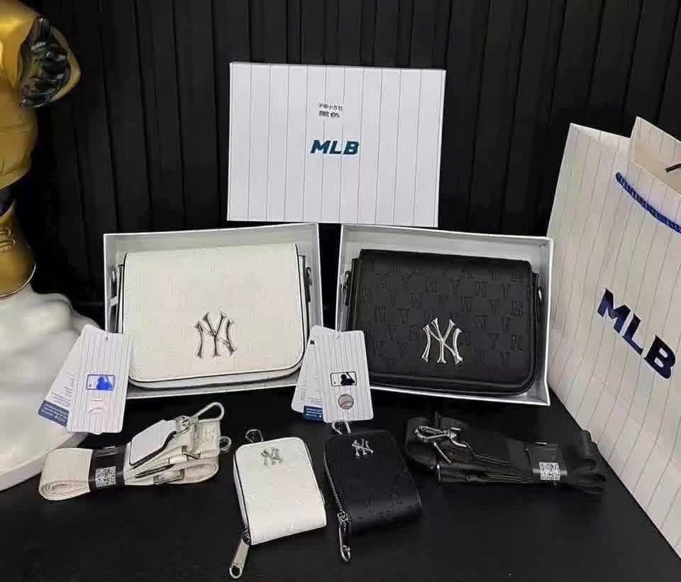 MLB Crossbody Bag Set Sling Bag (Category: Sling Bags) located in Manila. Submitted by sanghaya.mnl (Listing ID 1464923317, Image 3). Description: - Includes a matching mini pouch coin purse for extra storage - Features premium metal Yankees logo hardware on the front - Comfortable, adjustable wide webbing strap included - Color options: Classic Black or Clean White - Original branding tags attached.