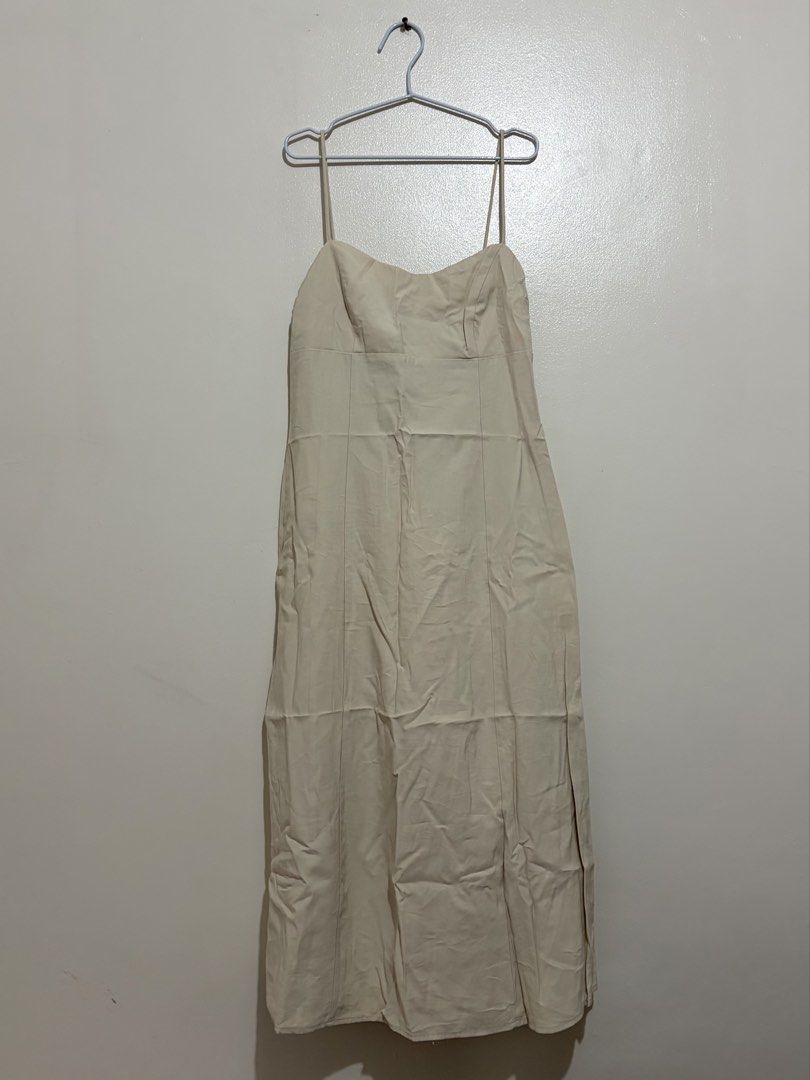 MANGO Beige Spaghetti Strap Midi Dress (Category: Dresses) located in Cainta. Submitted by knarv__ (Listing ID 1464882666, Image 1). Description: Neutral beige MNG midi dress in EUR M (USA 6). Features a sweetheart neckline, spaghetti straps, and chic panel seams. A versatile staple with some faint yellowish stains. Perfect for layering or casual days out!.