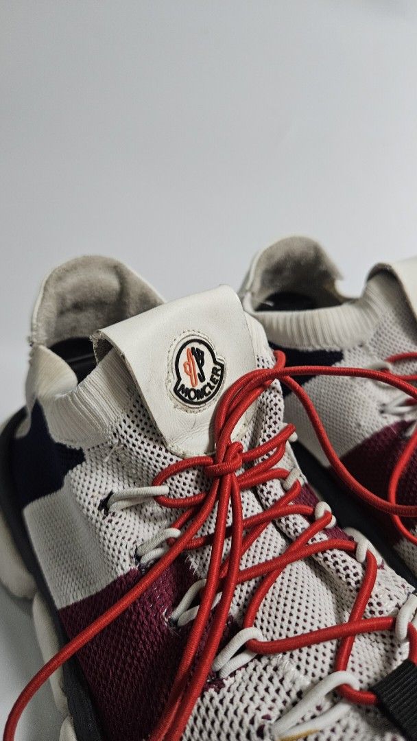 Moncler Bubble Sneakers (Category: Sneakers) located in Alfonso. Submitted by jbcamet (Listing ID 1464906844, Image 2). Description: - Brand: Moncler - Colorway: White, red, and dark blue knit fabric - size 8 / 26cm - Design: Sock-like slip-on with bright red toggle laces and white leather pull tabs with logo badge - Soles: Chunky white rubber soles - Condition: Shows light wear on insoles and uppers with minor scuffs on the soles - Style: Comfor