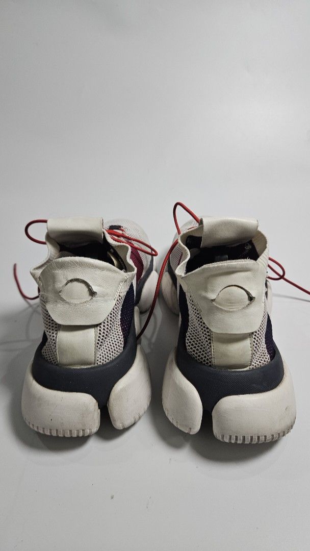 Moncler Bubble Sneakers (Category: Sneakers) located in Alfonso. Submitted by jbcamet (Listing ID 1464906844, Image 3). Description: - Brand: Moncler - Colorway: White, red, and dark blue knit fabric - size 8 / 26cm - Design: Sock-like slip-on with bright red toggle laces and white leather pull tabs with logo badge - Soles: Chunky white rubber soles - Condition: Shows light wear on insoles and uppers with minor scuffs on the soles - Style: Comfor